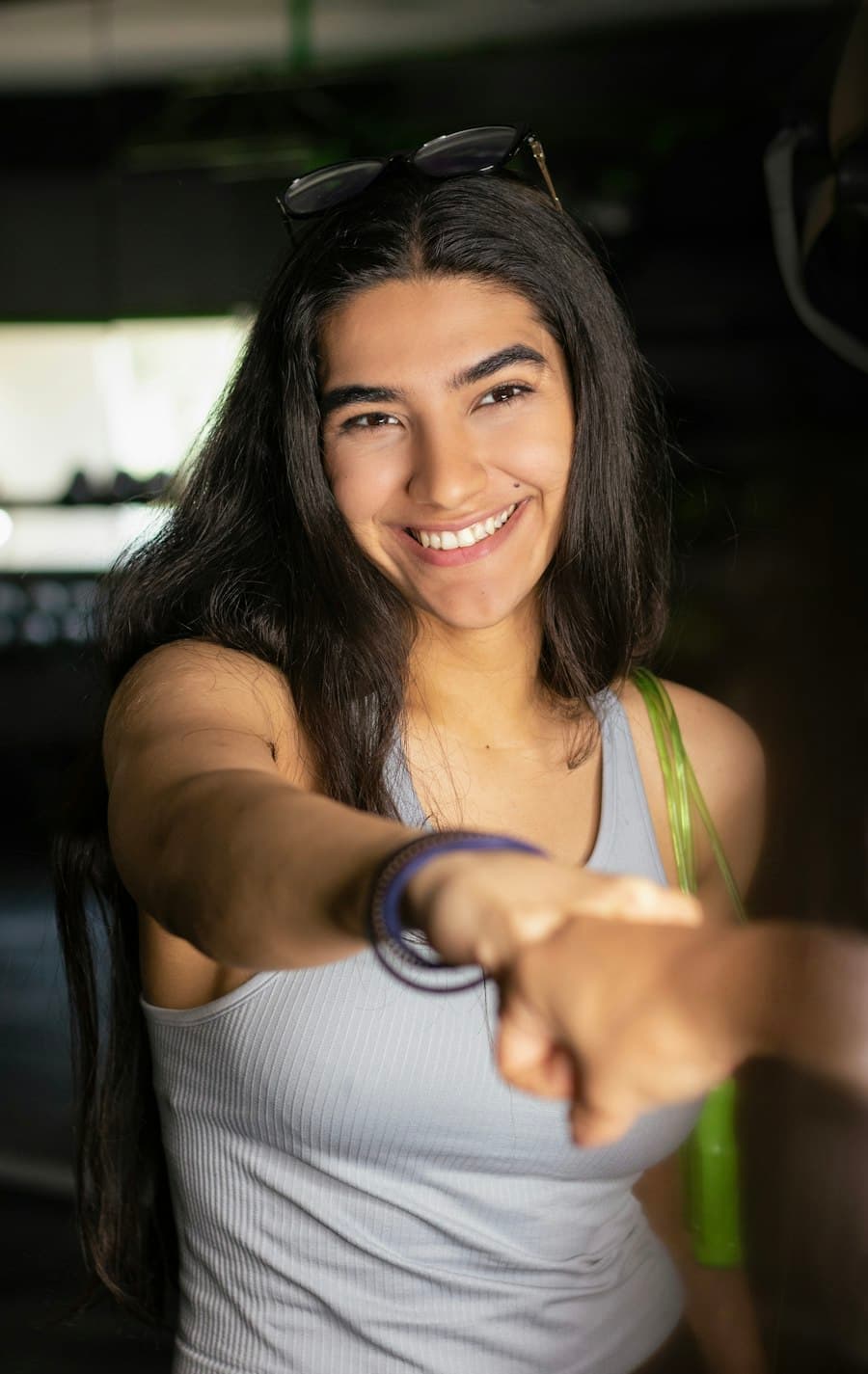 A smiling client offers a fist bump to her coach